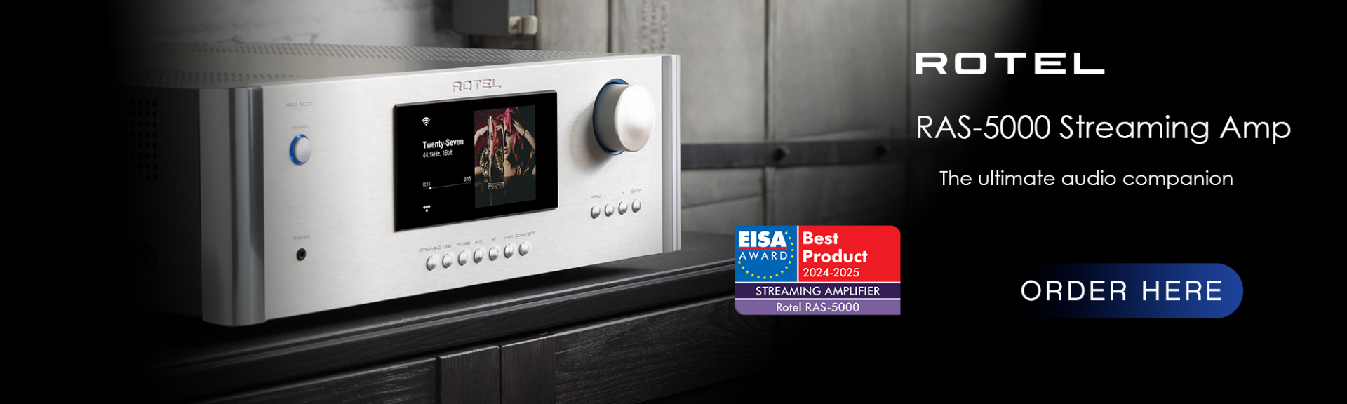 Rotel RAS-5000 Lifestyle shot. Silver amp on black cabinet